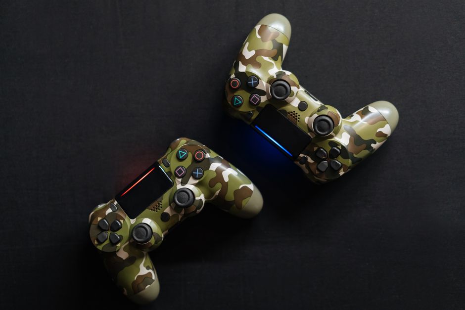 Close-up of two camouflage game controllers, perfect for gaming enthusiasts.