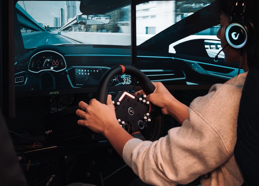 Person engaging in a realistic driving simulation with advanced gear and visuals.